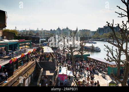 The South Bank of the River Thames in London, seen from Waterloo Bridge, on a busy weekend. Stock Photo