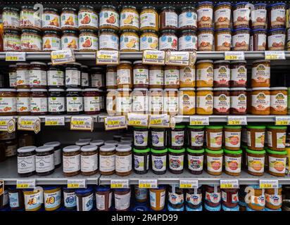 Italy - May 25, 2023: different kinds of organic jam and 100% fruit jam in glass jars on shelf for sale in Italian supermarket. tex: prodotto bio (org Stock Photo