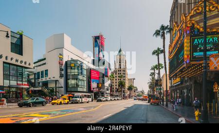 Hollywood, California, USA - April 26, 2023. Crowded Hollywood Boulevard. An iconic El Capitan theatre, the Ovation Center, traffic, walking tourists, Stock Photo