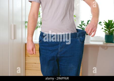 Panorama, Man shows off weight loss, baggy pants Images, Photography, Stock  Pictures, Archives, Fine Art Prints