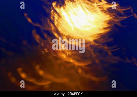 Blured abstract background with warm orange shapes and cold dark blue surroundings. Graphic resources Stock Photo