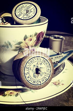 Vintage Tea cup and saucer with sewing kit Stock Photo