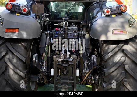Chisinau, Moldova, October 22, 2019. Rear view of the mechanisms and systems of the tractor, located behind the driver's cab between two large black w Stock Photo