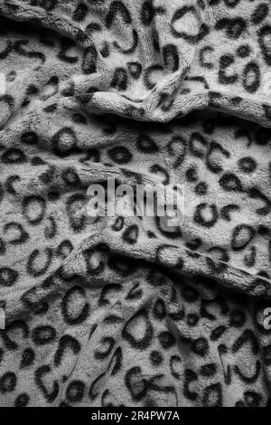 Soft fleecy faux fabric with a mottled pattern. Light leopard texture. Stock Photo