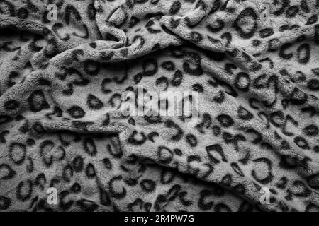 Soft fleecy faux fabric with a mottled pattern. Light leopard texture. Stock Photo