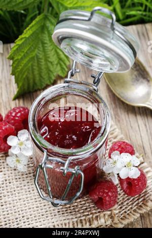 Bowl of raspberry jam on a wooden table. Healthy food Stock Photo