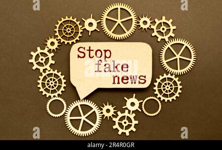 stop fakes - two red buttons on laptop keyboard. finger tries to press stop fake buttons on a gray laptop. false news, facts and feelings in the moder Stock Photo