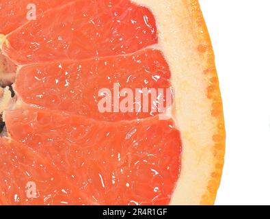 Close-up of a grapefruit slice on white background. Slice of ripe grapefruit. Close-up of fresh grapefruit slice on wite background. Macro horizontal Stock Photo