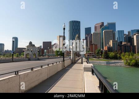 Pano views along Centre St Bridge in Calgary, Alberta on a blue sky day with city skyline in view, tower, sky scrapers in scenic skyscape landscape. Stock Photo