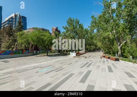 Scenic views along the Bow River pathway area for pedestrians, bicycles during summer spring on beautiful blue sky day. Stock Photo