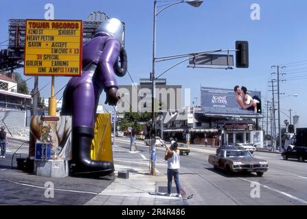 A workman installing an inflatable advertising balloon in front of ...