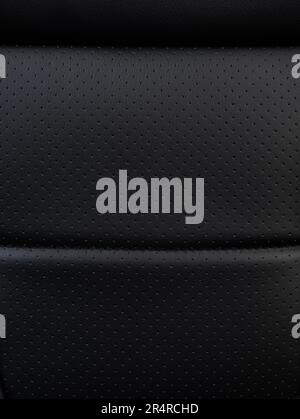 Clean black perforated leather textur plane macro close  up view Stock Photo
