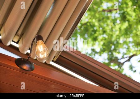 light bulb on celling at home with open roof  Stock Photo