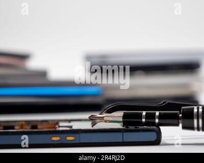 Cell phone parts and tools, phone repair, smartphone and mobile technology upgrades. The concept of repair and diagnostics of smartphones. Stock Photo