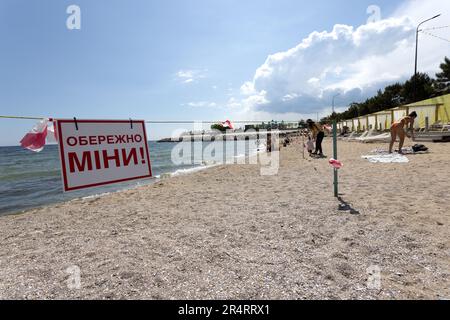 ODESSA, UKRAINE - MAY 15, 2023: mine hazard sign on city sea sandy beach in Odessa during the Russian attack on Ukraine. Swimming is prohibited! Appro Stock Photo