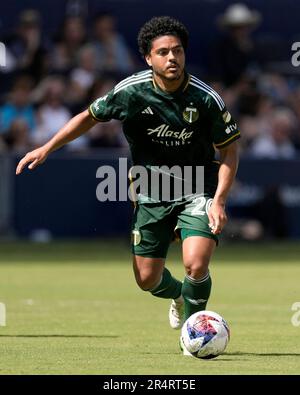 Kansas City, USA. 28th May, 2023. Portland Timbers midfielder Evander (20,  left) moves the ball as Sporting Kansas City midfielder Roger Espinoza (15)  tries to reach it with his foot. Sporting KC