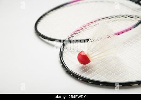 Shuttlecocks and badminton rackets on grey background. Top view. Stock Photo