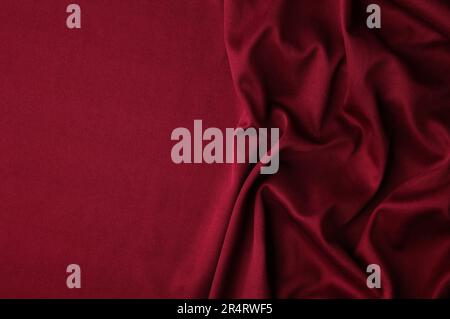 Smooth elegant burgundy silk or satin luxury cloth texture can use as abstract background. Luxurious background design. Top view Stock Photo