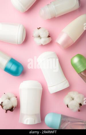 White deodorants with cotton on pink background. Top view. Stock Photo