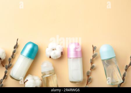 White deodorants with willow twigs on beige background. Top view. Stock Photo