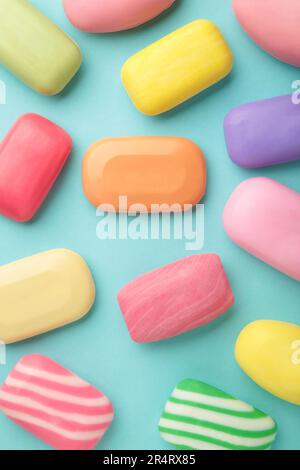 Different soaps in different soap dishes. A lot of solid soap for hygiene and cleanliness. Colorful soap and remnants are scattered on blue background Stock Photo