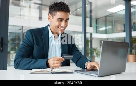 Credit card, business man and laptop with online banking, payment and ecommerce store. Office, male professional and smile of a corporate worker with Stock Photo