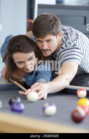 fashionable couple playing pool table billiards snooker Stock Photo