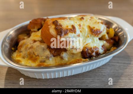 Cheese baked rice with pork chop and tomato Stock Photo