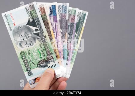 Cambodian money - riel in the hand on a gray background Stock Photo