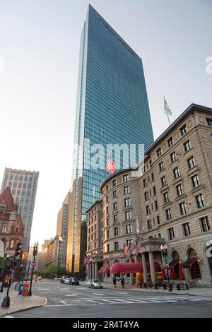 USA, Massachusetts, Boston, John Hancock Tower with old Fairmont Copley Plaza hotel and road at sunset. Stock Photo