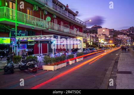 View of Taormina and Giardini Naxos promenade viewed from Giardini Naxos at dusk, Sicily, Mediterranean, Italy, Europe Stock Photo