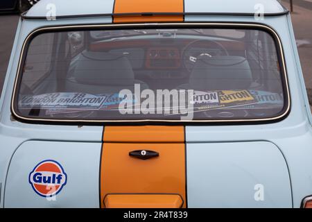 Brighton, UK - May 19 2019:  Rear window detail view of a pale blue and orange stripe Mini taking part in the London Brighton Mini Run 2019. Stock Photo