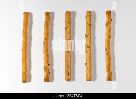 Top view of pile of tasty classic crunchy crispy long pastry breadsticks isolated on white background Stock Photo