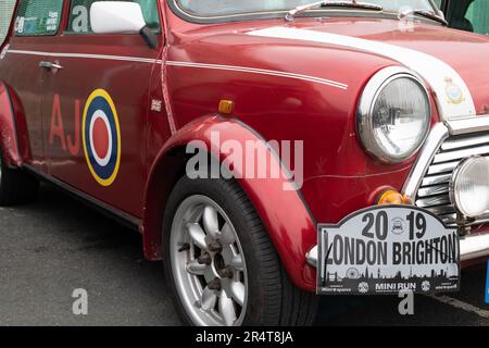 Brighton, UK - May 19 2019:  A detail of the side of a Mini car taking part in the London Brighton Mini Run 2019. The colour is metallic red. Stock Photo