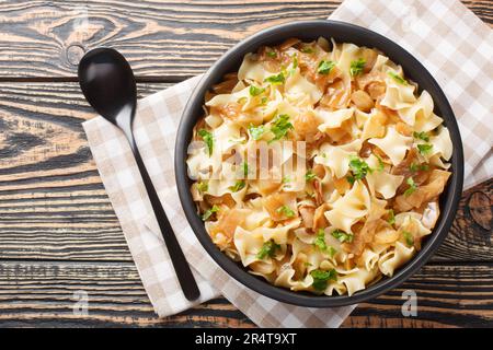 Noodles with stewed cabbage Austrian cuisine closeup on the bowl on the table. Horizontal top view from above Stock Photo