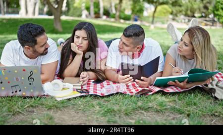 Group of people students using touchpad and laptop studying at park Stock Photo