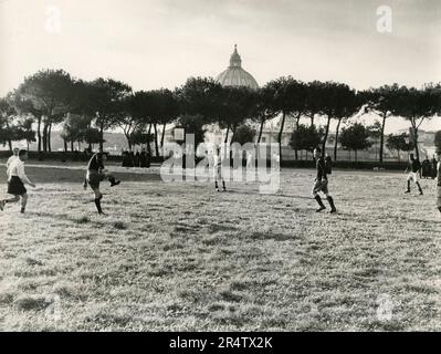 Children playing football in Villa Pamphili, Rome, Italy 1960s Stock Photo