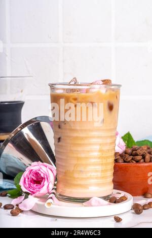 Iced Rose flower latte coffee drink, with pink rose petals taste almond milk, espresso, crushed ice, Stock Photo