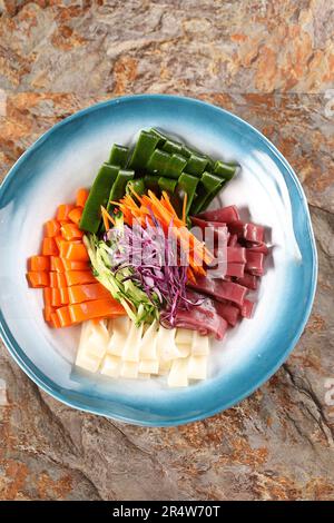 Tossed Mung Clear Noodles in Sauce，Liangpi，Chinese dish composed of cold skin noodles made from wheat or rice flour，Chinese snack rice noodles Stock Photo