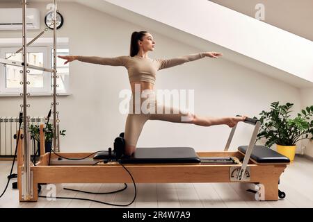 Pilates Reformer Workout Exercises Woman Brunette At Gym Indoor. Stock  Photo, Picture and Royalty Free Image. Image 47935407.