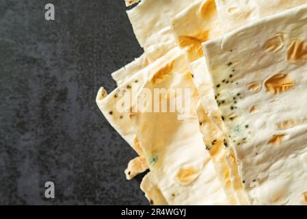 Spoiled pita, moldy. Mildew on the bread. Gray background. copy space Stock Photo