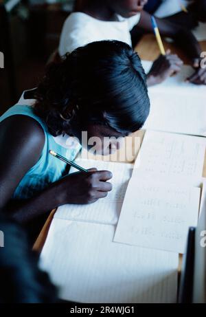 Australia. Northern Territory. Education. Aboriginal schoolgirl writing. Stock Photo