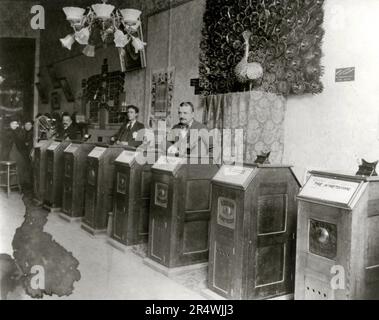 Albert Einstein's 'Peep Show' Kinetoscope Arcade. The kinetoscope was an early motion picture exhibition device that allowed films to be viewed by one person at a time through a peephole viewer window on top. This was the basic model for later movie projections. Stock Photo