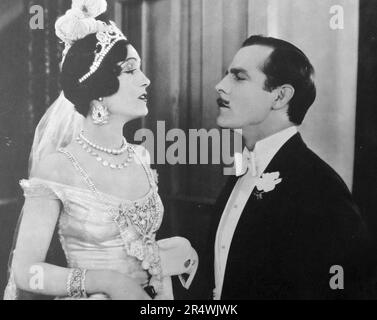 Hauteur at its height.  The studio caption says 'Lord St. Austel (Antonio Moreno) tells his bride (Pauline Starke) that she has discredited the family name, in a scene from Love's Blindness, 1926, an Elinor Glyn production for Metro-Goldwyn-Mayer. Stock Photo