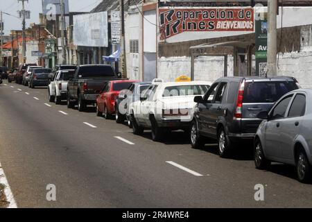 Venezuelans get up early and line up in long lines, for eight and 12 hours this Sunday, May 28, to be able to fill their vehicles with gasoline, in the city of Maracaibo, Venezuela. The queues are due to the shortage of fuel, generated by failures in the distribution to the service stations, and which exceed two kilometers of cars. Until waiting for the arrival of the tanker trucks, from the state-owned Petróleos de Venezuela (PDVSA) with the dispatch. The arrival of the fuel at the gas stations does not have a fixed time or date, since the distribution depends on the arrival of the ships. To Stock Photo