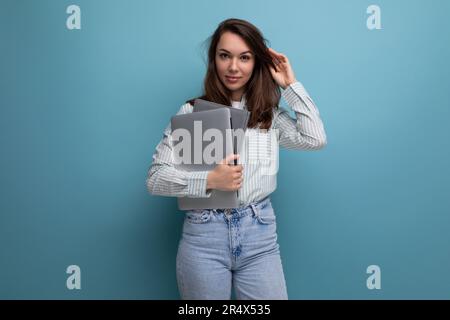 european slim 25 year old young brown-haired business woman holding a laptop for design Stock Photo