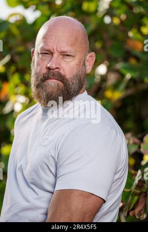 Bearded man posing in a white shirt Stock Photo