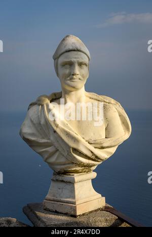 Close-up of a marble bust with ocean background along The Terrace of Infinity at Villa Cimbrone; Ravello, Salerno, Italy Stock Photo