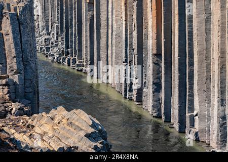 Close-up of the basalt columns of Stuðlagil Canyon in Northeastern Iceland, creating an amazing and surreal landscape Stock Photo