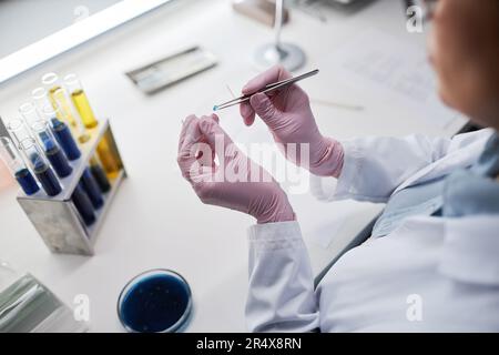 Top view closeup of female scientist preparing test material while doing research in laboratory, copy space Stock Photo